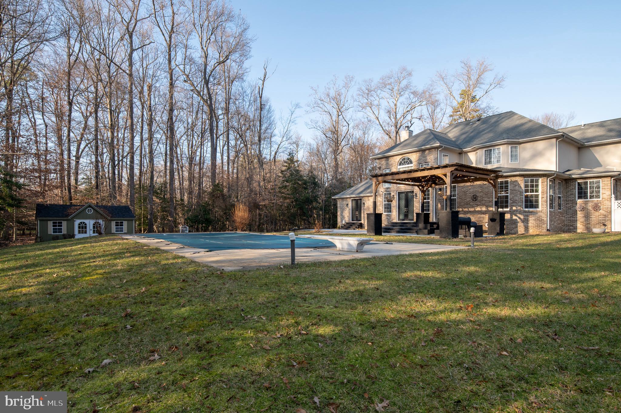 16301 Accolawn Road Accokeek, MD 20607 - Photo 65 of 77 a view of a big house with a big yard and large trees