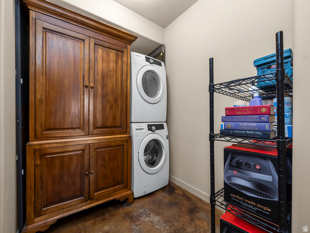 22677 East Snowbird Drive, Unit 47 Helper, UT 84526 - Photo 32 of 43 Laundry room with concrete flooring, stacked washer / dryer, and cabinet space