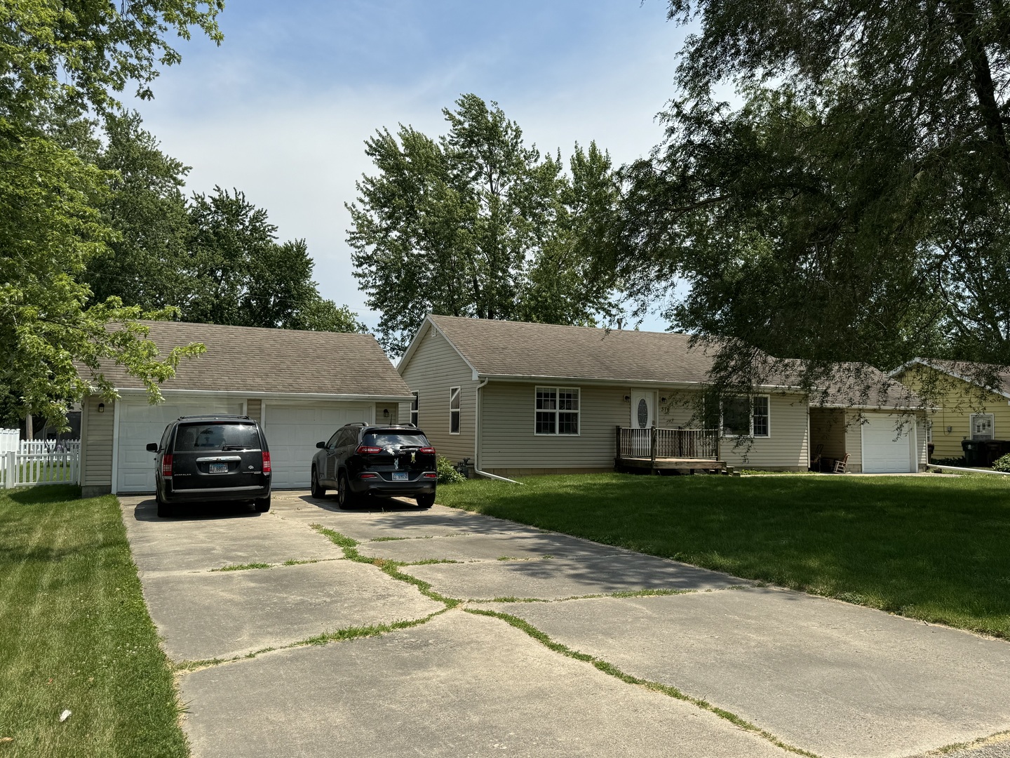 374 North Park Road Herscher, IL 60941 - Photo 4 of 16 a car parked in front of a white house