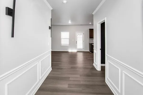 a view of hallway with wooden floor