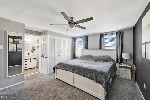 a spacious bedroom with a bed and a large mirror