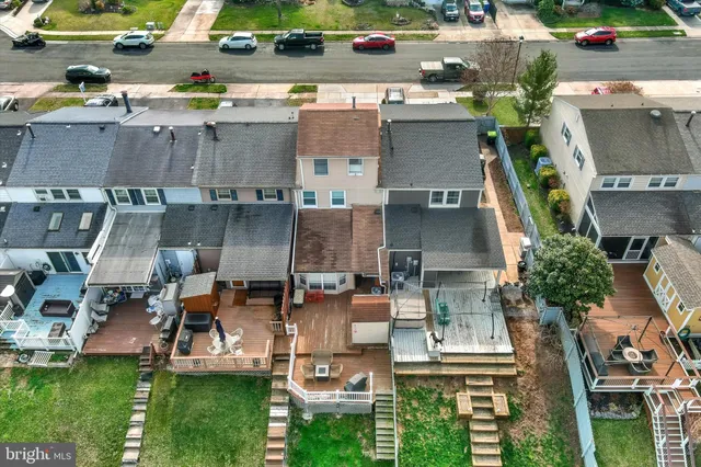an aerial view of multiple houses with a yard