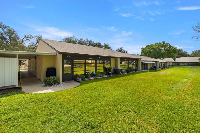 an aerial view of a house with a yard basket ball court and outdoor seating
