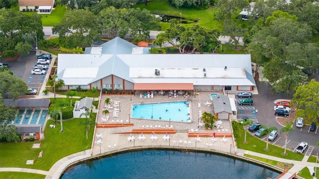 a view of a pool with a bench and yard