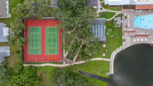an aerial view of residential houses with outdoor space and swimming pool