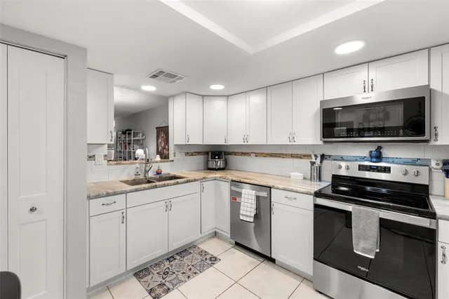 a kitchen with a sink stove and microwave