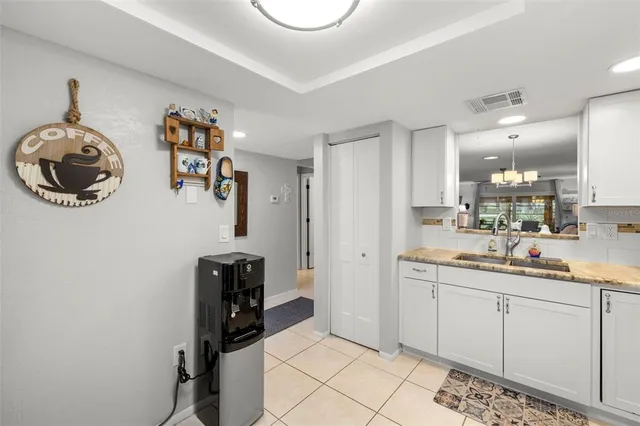 a dining room with furniture a chandelier and wooden floor