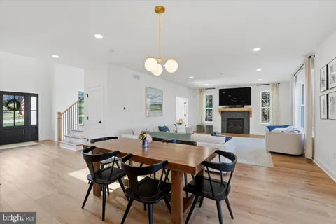 a living room with furniture and view of kitchen