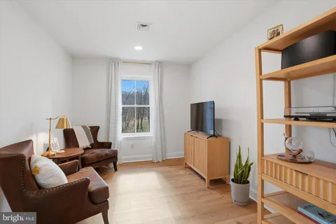 a spacious bathroom with double sink a toilet a mirror and shower