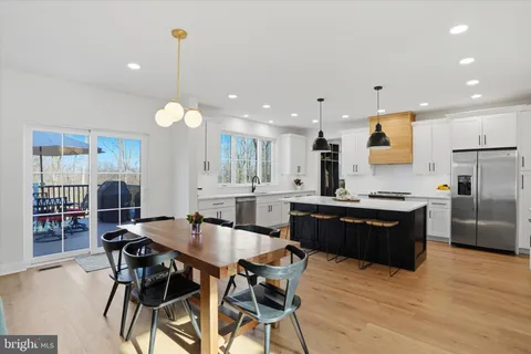 a large kitchen with kitchen island a sink counter space and appliances