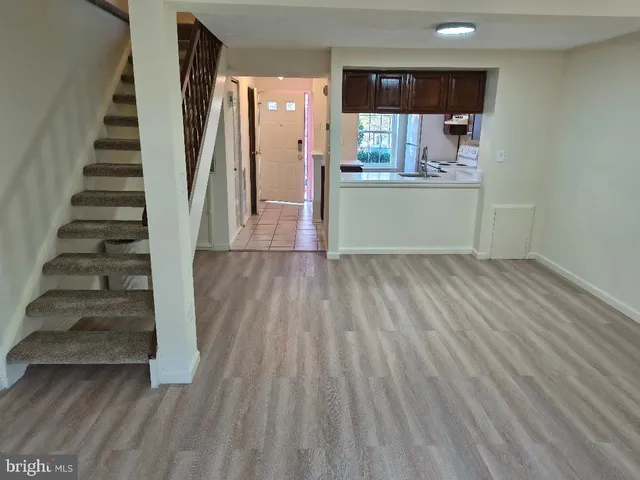 a view of a kitchen with wooden floor and electronic appliances