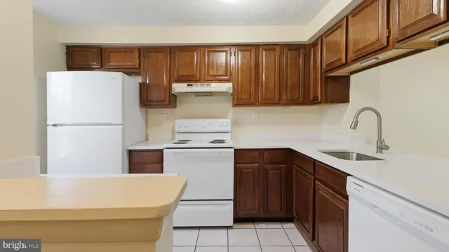 a kitchen with a refrigerator and a sink