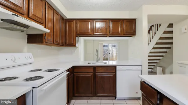 a kitchen with stainless steel appliances a stove and a microwave