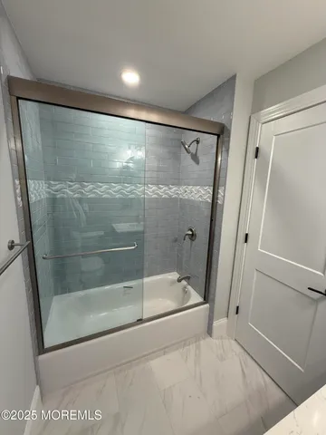 a bathroom with a glass shower door