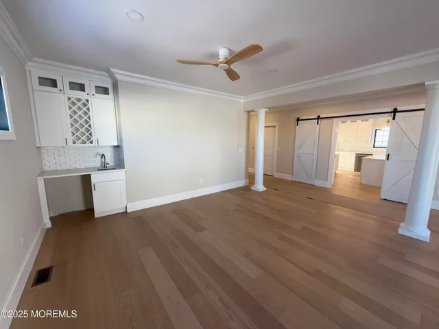 a view of empty room with wooden floor