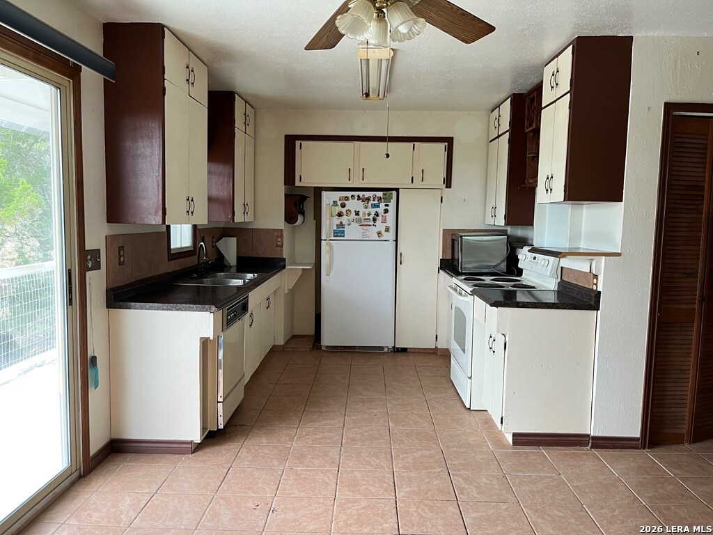 522 Medina Hills Road Medina, TX 78055 - Photo 6 of 15 a kitchen with stainless steel appliances a sink stove and refrigerator