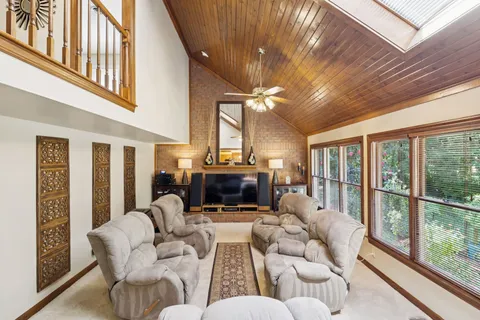 a living room with furniture a fireplace and a large window