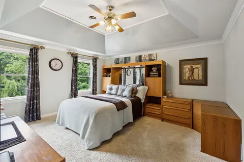 a bedroom with a bed and a chandelier