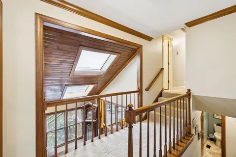a view of staircase with railing and windows