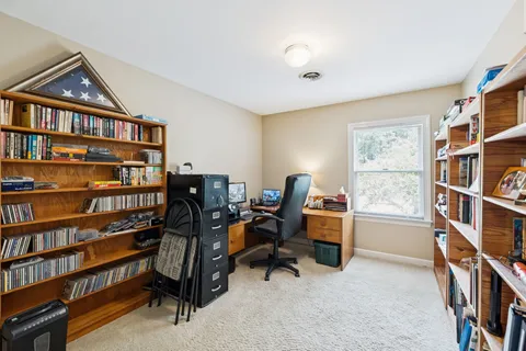 a view of a workspace with bookshelf