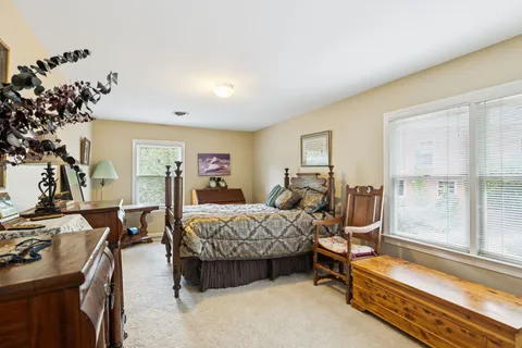 a bedroom with furniture and a large window