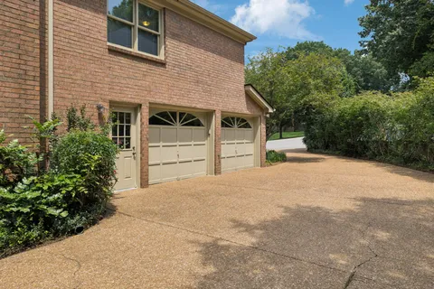 a view of a house with a yard and garage