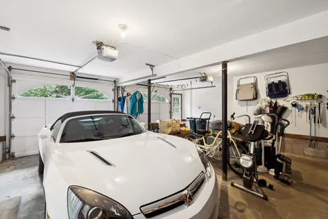 an aerial view of a house with a yard and lake view