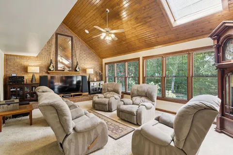 a living room with furniture a fireplace and a large window