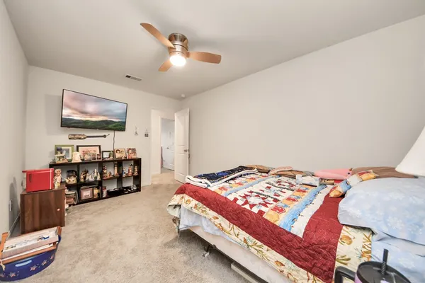 a bedroom with a bed and a chandelier