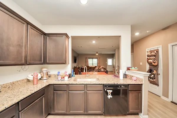 a kitchen with stainless steel appliances granite countertop a sink stove and cabinets