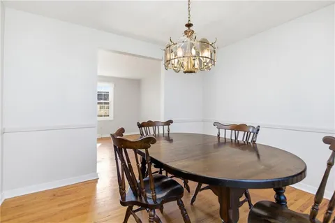 a view of a dining room with furniture and chandelier