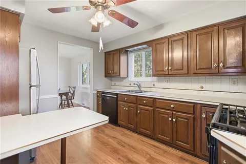 a kitchen with a sink cabinets and wooden floor
