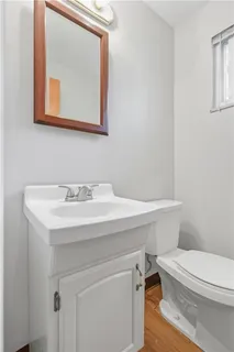 a bathroom with a sink a toilet and mirror