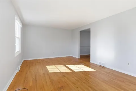 an empty room with wooden floor