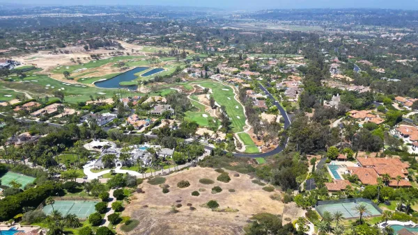 an aerial view of residential houses with outdoor space