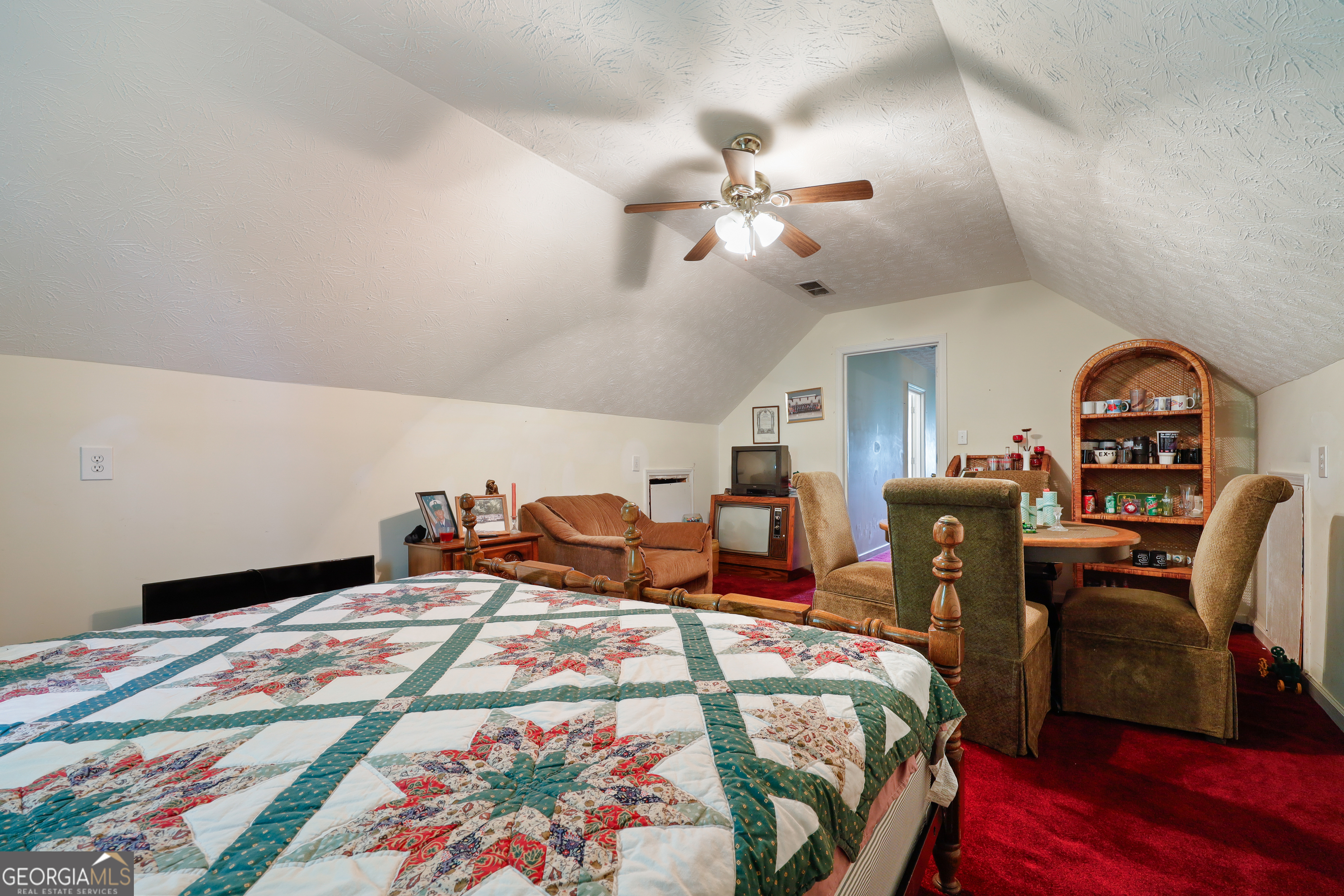 2433 Bear Creek Road Statham, GA 30666 - Photo 33 of 58 a bed room with bed and a chandelier