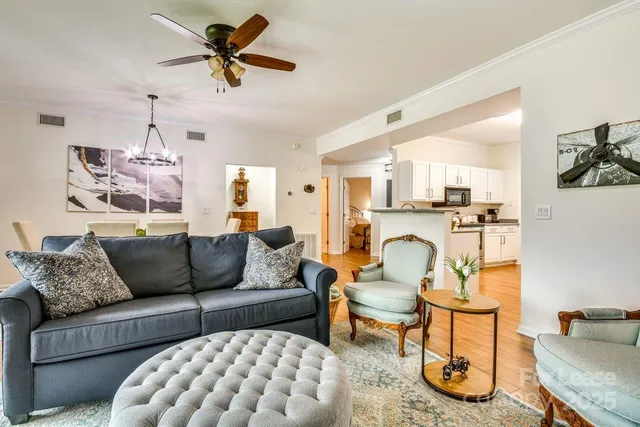 a living room with furniture and kitchen view