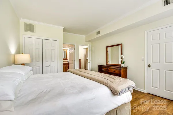 a bedroom with a bed and a closet