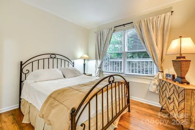 a bedroom with bed and a window