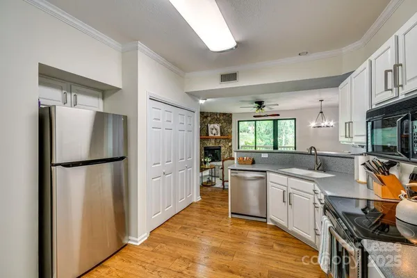 a kitchen with a sink a refrigerator and cabinets