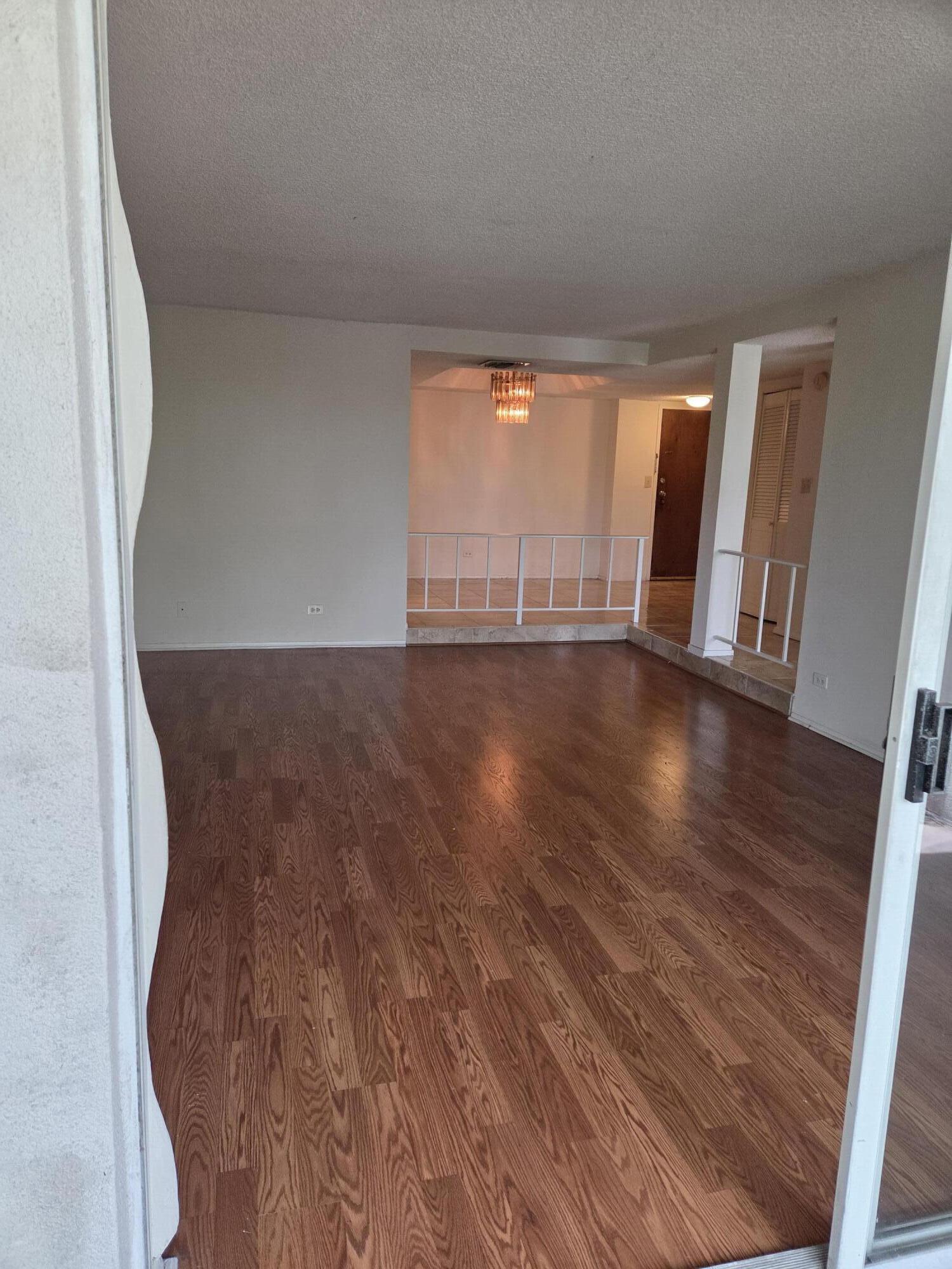 3720 Inverrary Drive, Unit 2B Lauderhill, FL 33319 - Photo 3 of 10 a view of an empty room with wooden floor and a window