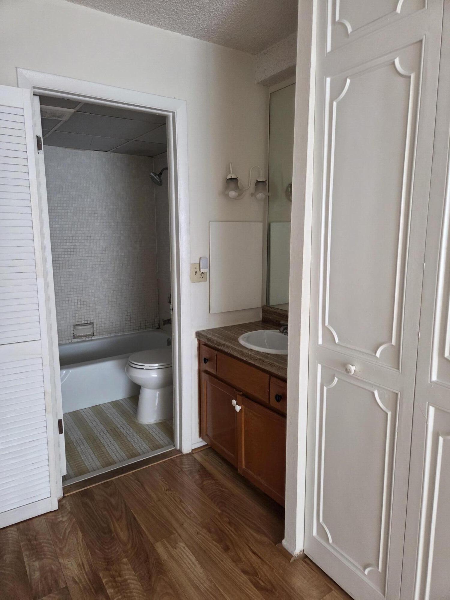 3720 Inverrary Drive, Unit 2B Lauderhill, FL 33319 - Photo 5 of 10 a bathroom with a sink and a toilet