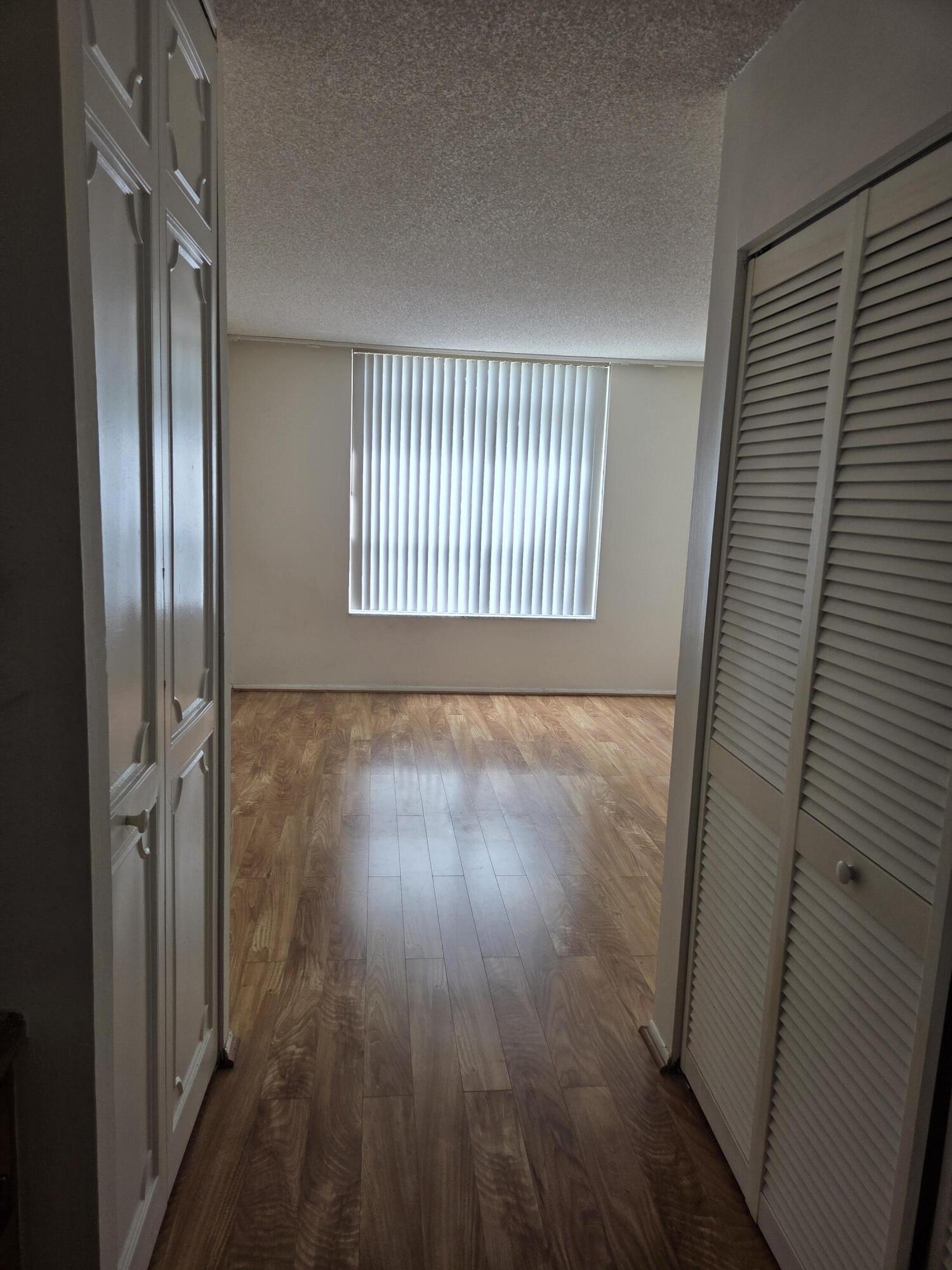 3720 Inverrary Drive, Unit 2B Lauderhill, FL 33319 - Photo 6 of 10 a view of a hallway with wooden floor and staircase
