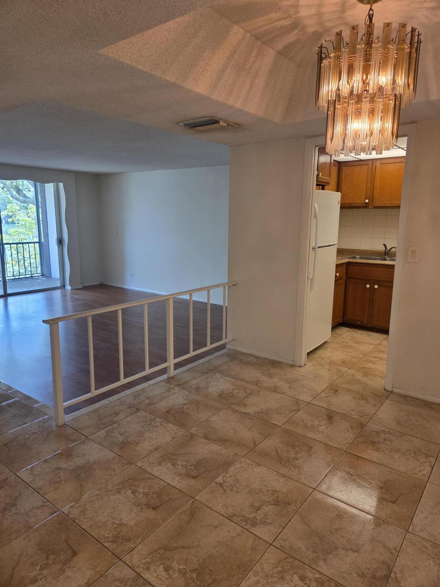 3720 Inverrary Drive, Unit 2B Lauderhill, FL 33319 - Photo 9 of 10 a view of an empty room with a kitchen