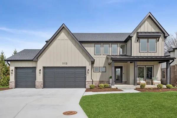 a front view of a house with swimming pool and porch with furniture