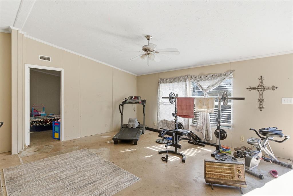 406 Hilltop Meadows Court Springtown, TX 76082 - Photo 14 of 33 a view of a room with gym equipment