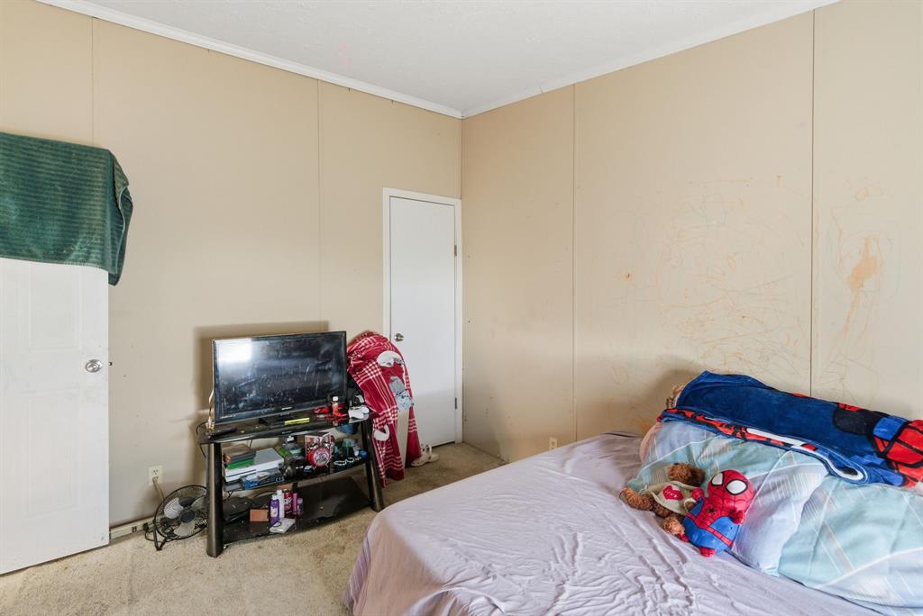 406 Hilltop Meadows Court Springtown, TX 76082 - Photo 18 of 33 a bedroom with a bed and a tv