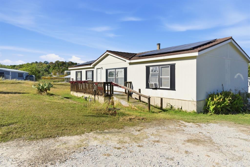 406 Hilltop Meadows Court Springtown, TX 76082 - Photo 2 of 33 a house with garden in front of it