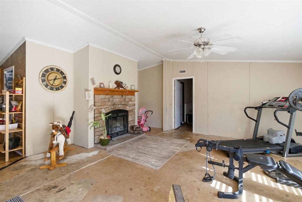 406 Hilltop Meadows Court Springtown, TX 76082 - Photo 21 of 33 a living room with furniture and a fireplace