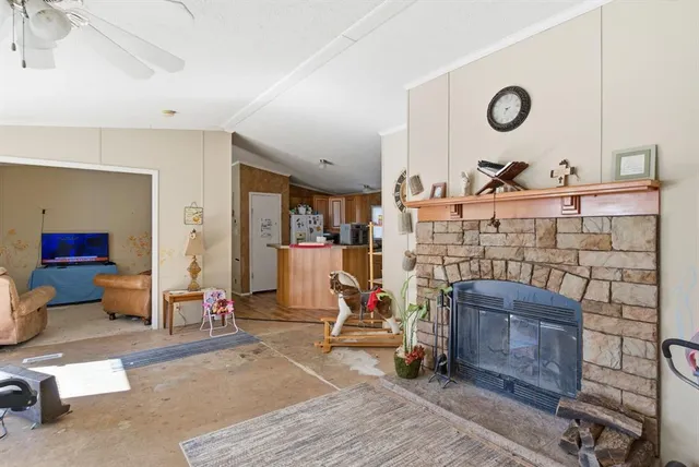 a living room with fireplace furniture and a wooden floor